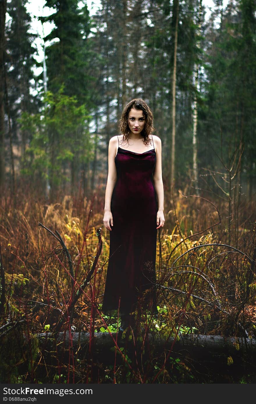 Full Length Portrait Of Woman In Purple Dress Under Rain