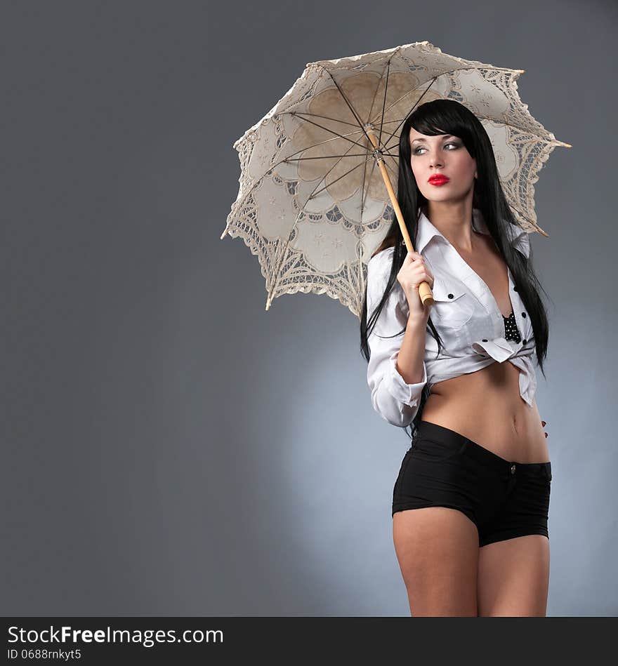 Young beautiful woman holding a bright umbrella. Young beautiful woman holding a bright umbrella