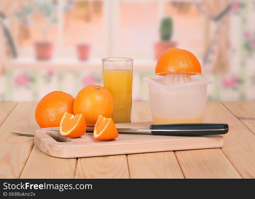 Knife, segments of orange and a juice glass