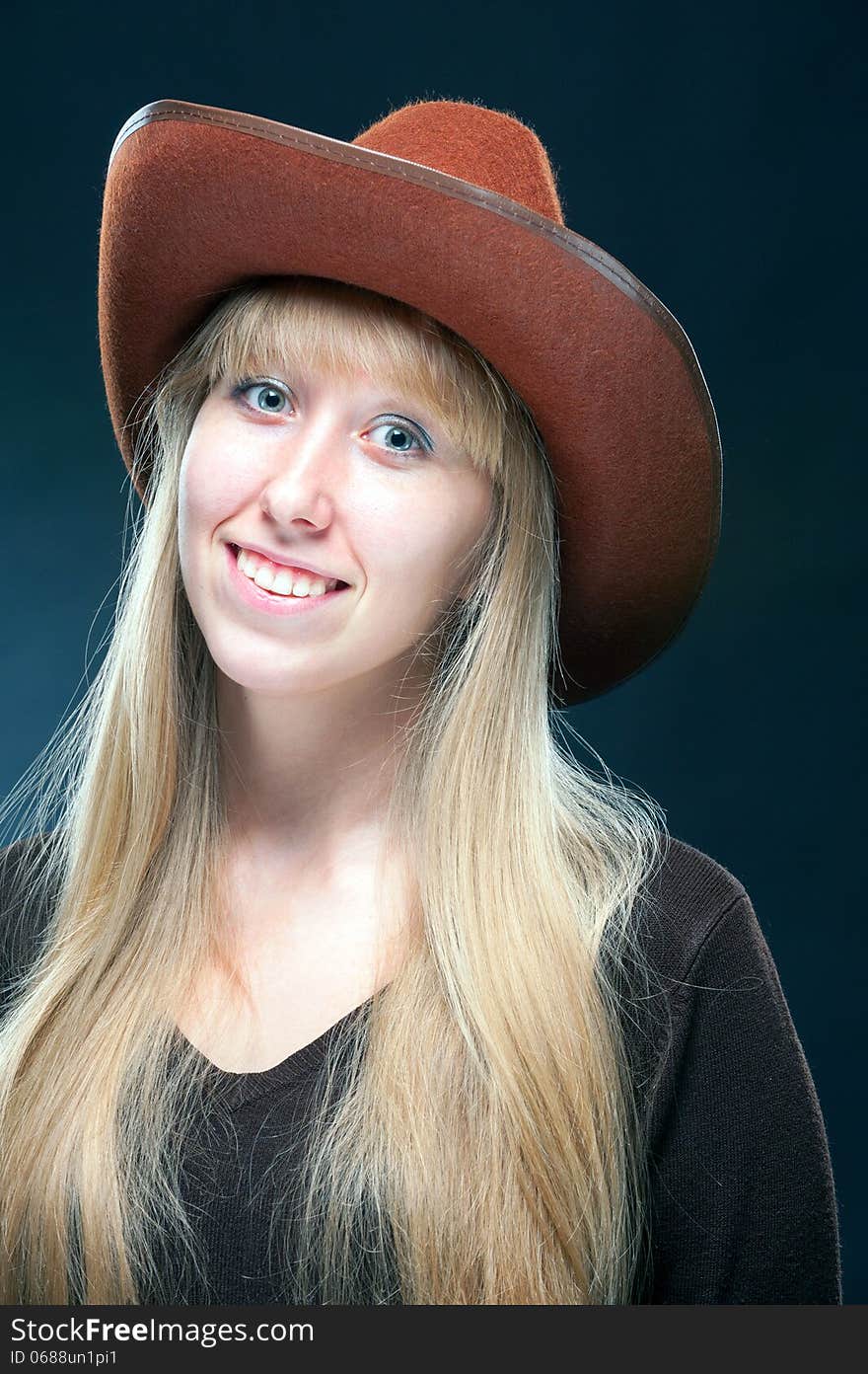 Portrait of a young blonde in a cowboy hat. Portrait of a young blonde in a cowboy hat