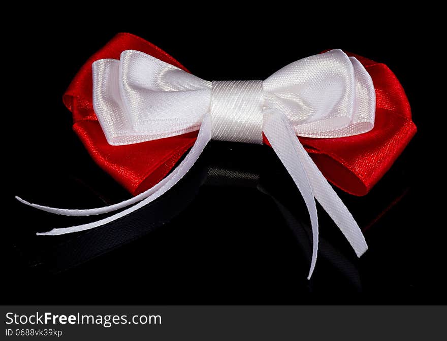 Red-white bow isolated on the black