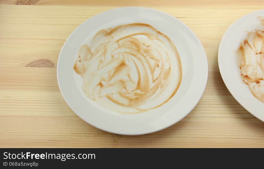 Wooden table. Three empty dirty plates. Men's hands is put fork and knife in the latest empty plate. Wooden table. Three empty dirty plates. Men's hands is put fork and knife in the latest empty plate