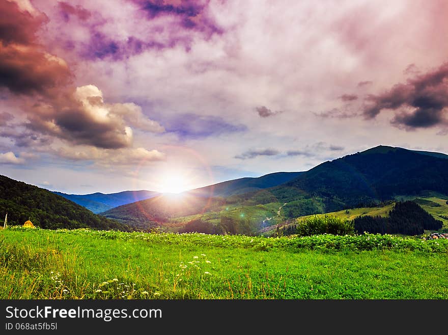 Valley near forest on a steep mountain slope after the rain in evening mood