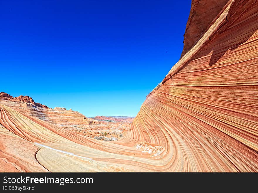 Hiking through The Wave is comparable to walking through a spectacular maze of swirling, undulating rock. Hiking through The Wave is comparable to walking through a spectacular maze of swirling, undulating rock.