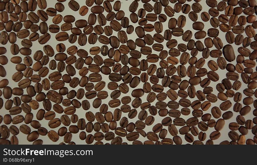 Whole grains are roasted coffee. Man's finger paints the symbol of coffee. Whole grains are roasted coffee. Man's finger paints the symbol of coffee