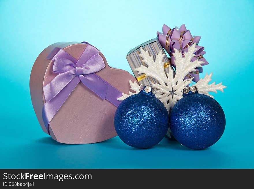 Two gift boxes, Christmas toys and snowflake on a blue background