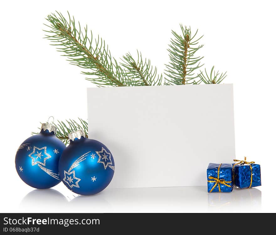 The fir-tree branch, two Christmas toys, small gift boxes, and the empty card isolated on white