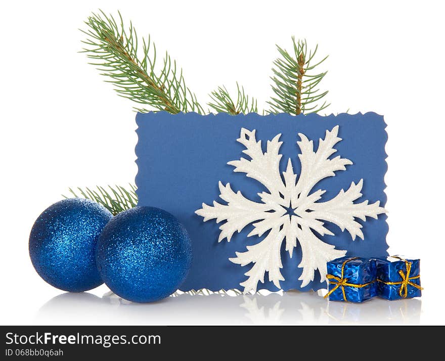 The fir-tree branch, two Christmas toys, small gift boxes, snowflake and the empty card isolated on white. The fir-tree branch, two Christmas toys, small gift boxes, snowflake and the empty card isolated on white