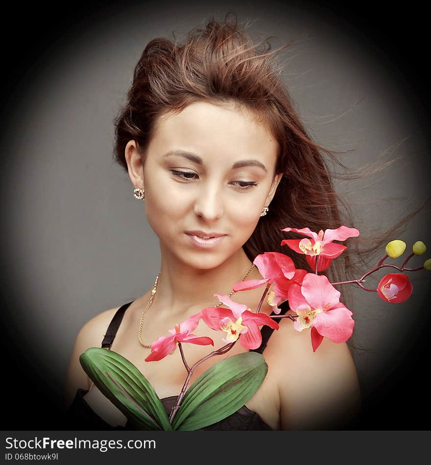 Young caucasian woman with orchid