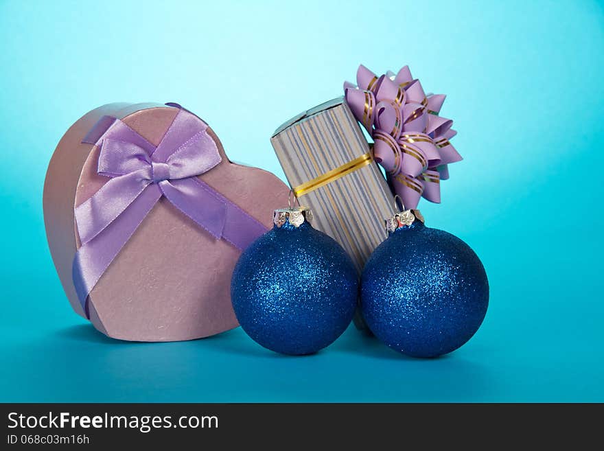 Two gift boxes and Christmas toys on a blue background