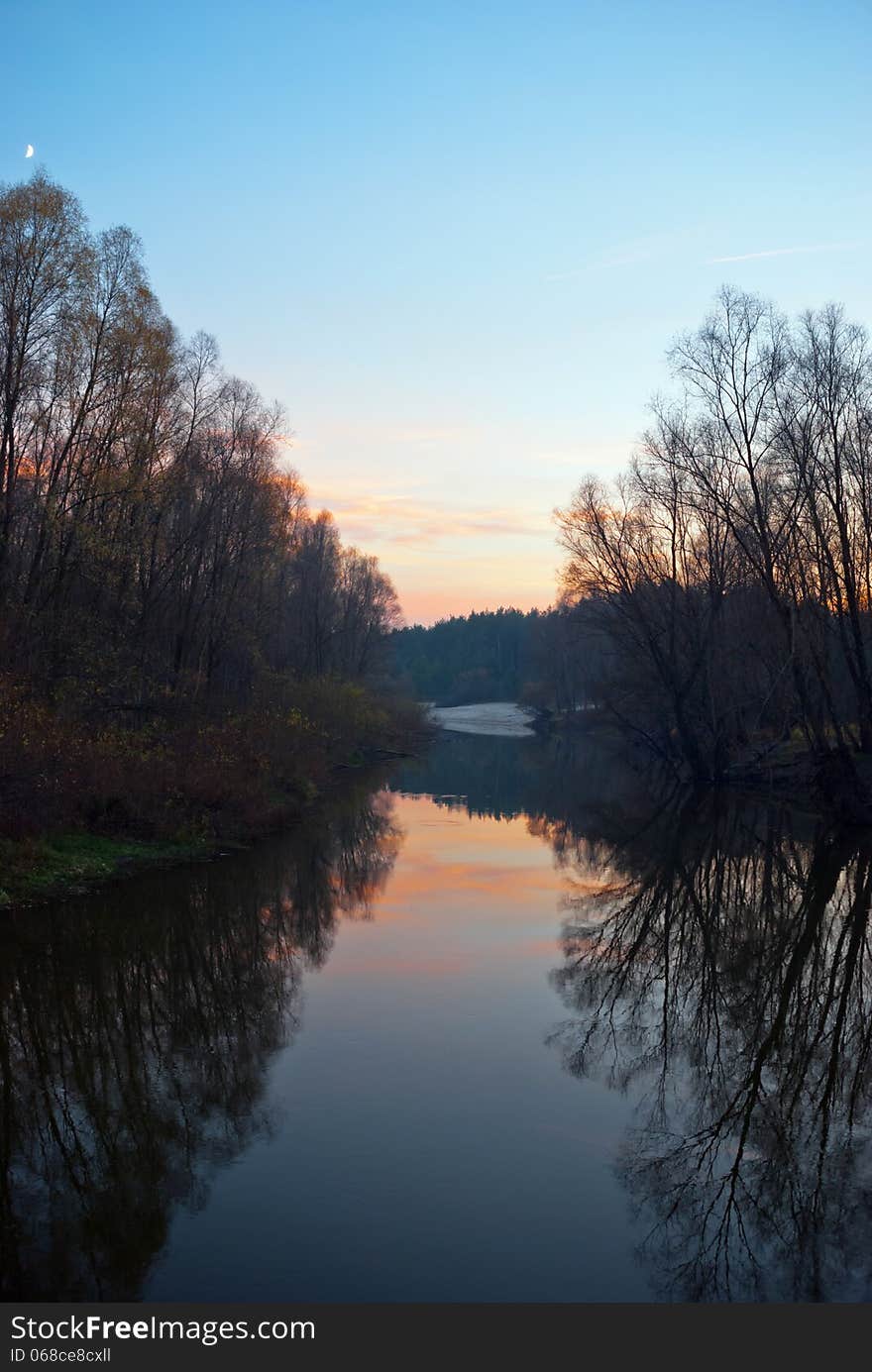 Evening landscape in autumn and reflections in water