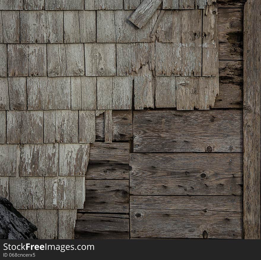 Decaying and peeling old wooden siding on a house