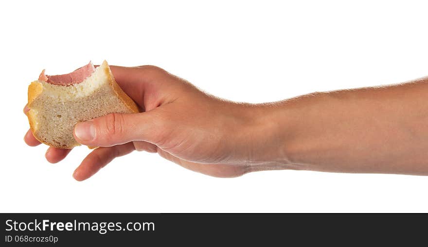 Sandwich from which bit off a slice, in the female hand, isolated on white