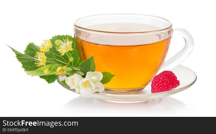 Cup of tea with a saucer, jasmine and linden flower, raspberry isolated on white