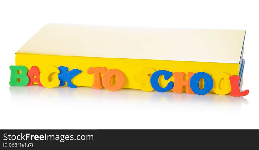 The book and set of plastic letters for the training, isolated on white. The book and set of plastic letters for the training, isolated on white