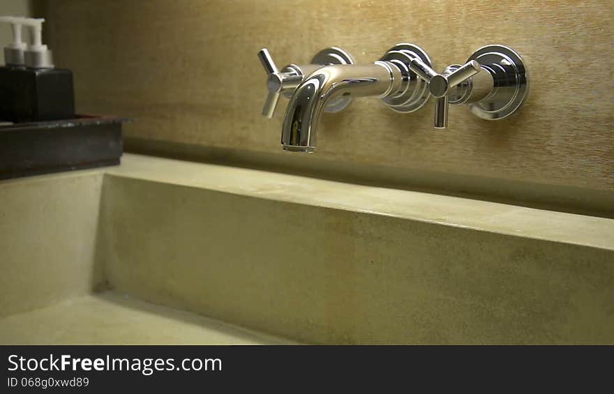 Hand open and close water tap faucet in the bathroom