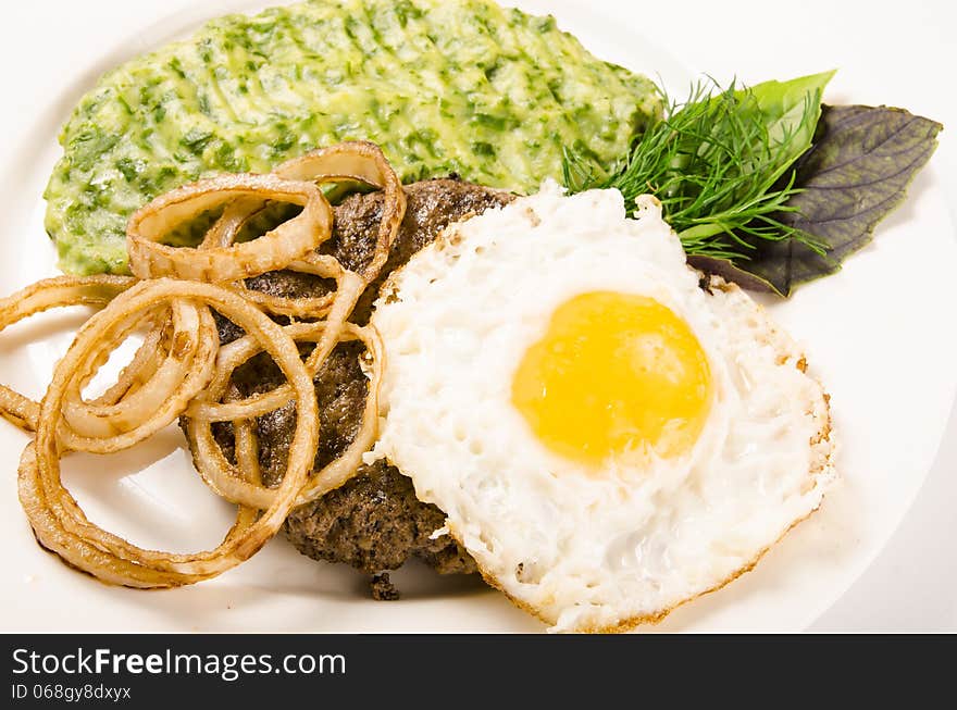 Beefsteak with egg onion and mashed potatoes