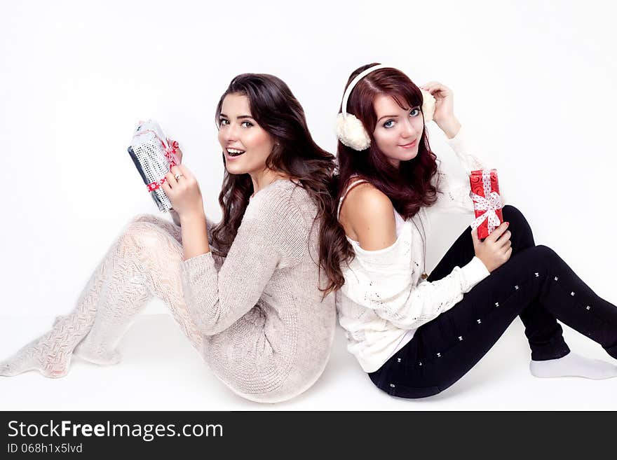 Two happy women opening christmas presents