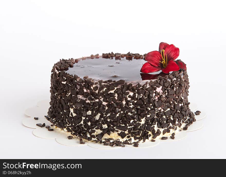 Chocolate Cake with Chocolate on uneven light background, cake isolated on warm light background with selective focus and uneven light. Concept. Birthday cake. Cake wit the shadow.