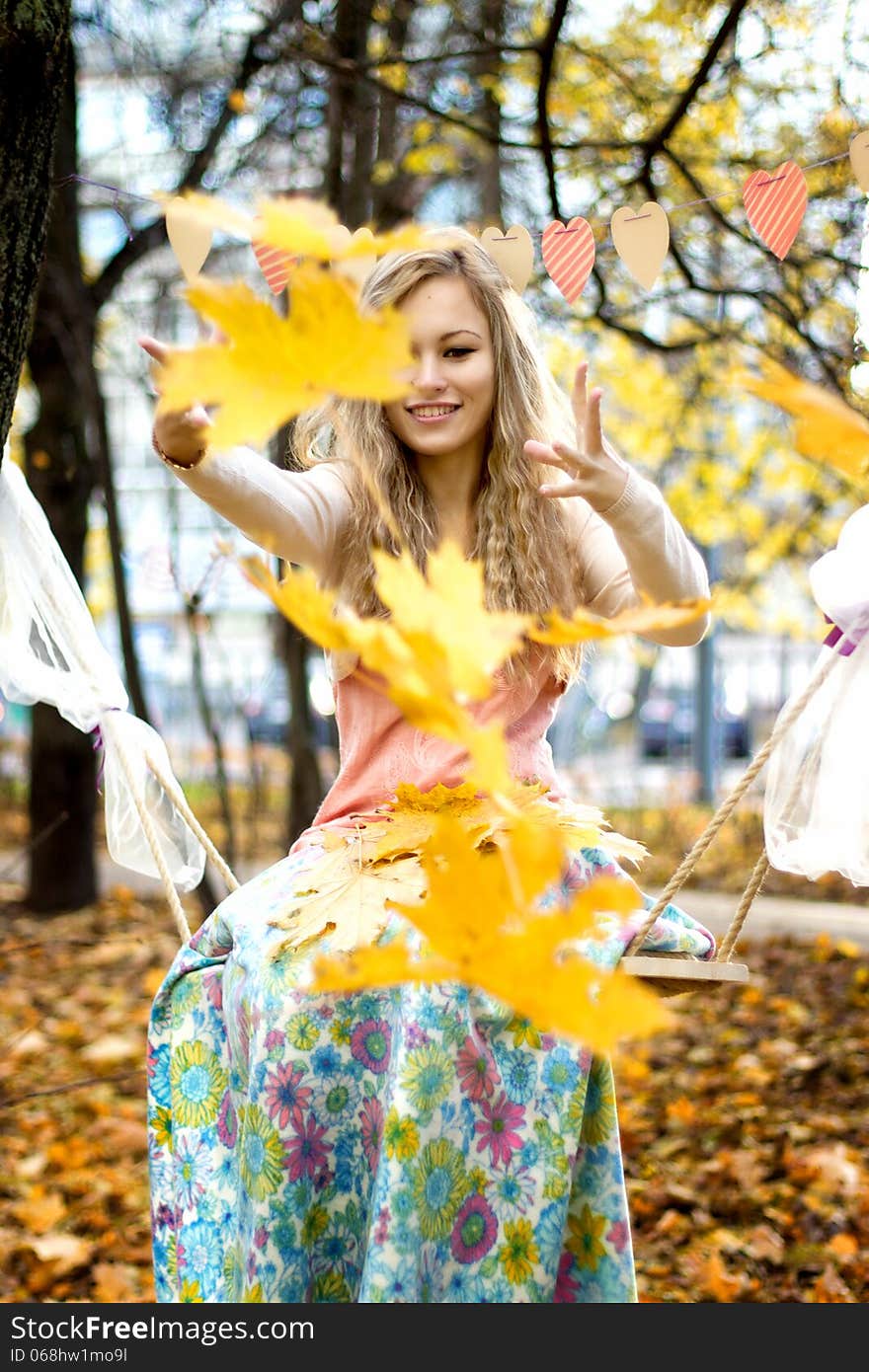 Happy girl throws autumn leaves. Happy girl throws autumn leaves