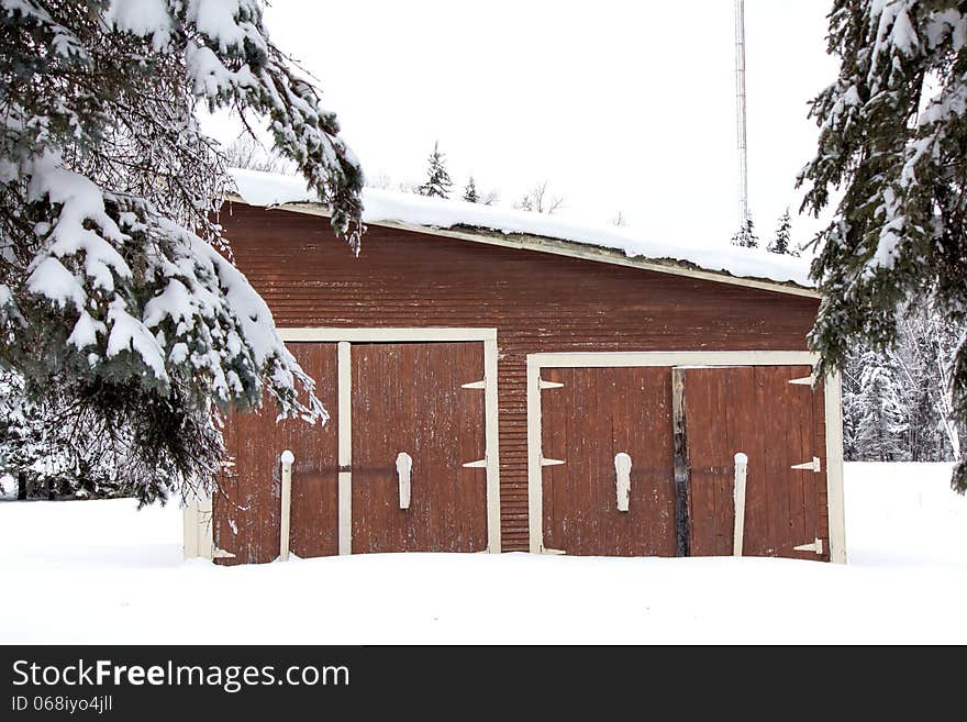 A brown shed in the snow