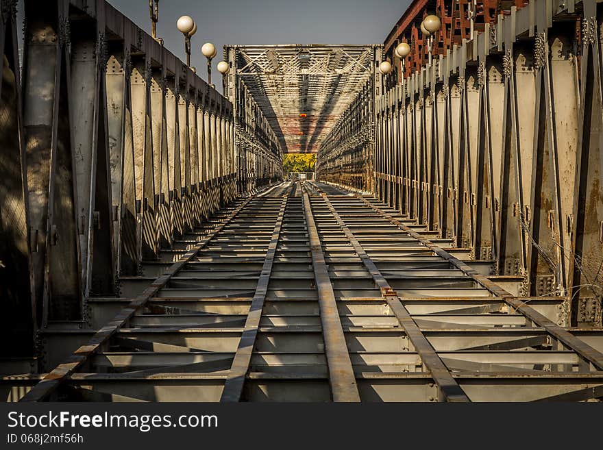 View down the bridge over the river in Bratislava. A pattern shot showing bridge girders. View down the bridge over the river in Bratislava. A pattern shot showing bridge girders