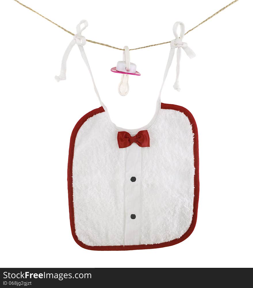 Baby bib with nipple hanging on rope isolated. Baby bib with nipple hanging on rope isolated