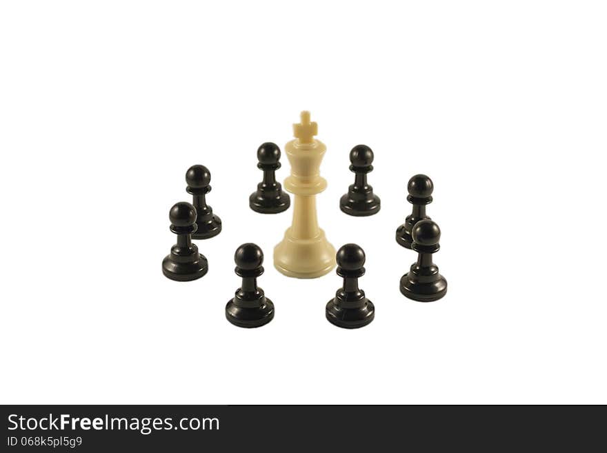 White king surrounded by the black pawns in a circle formation