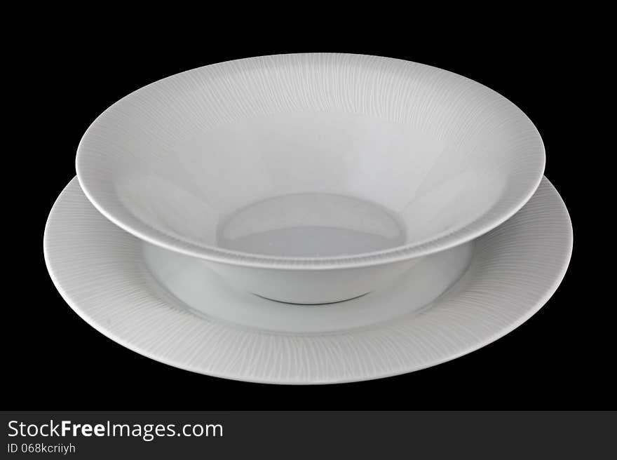 Set porcelain dinner plates on a black background. Set porcelain dinner plates on a black background.