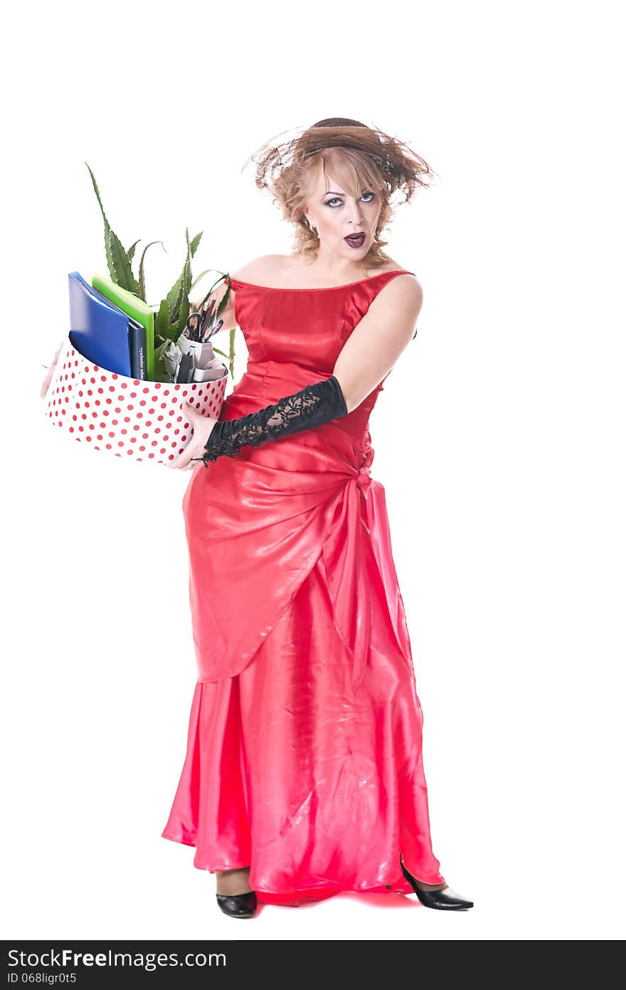 Fired actress in a red dress with a box of things express her emotions on a white background. Fired actress in a red dress with a box of things express her emotions on a white background