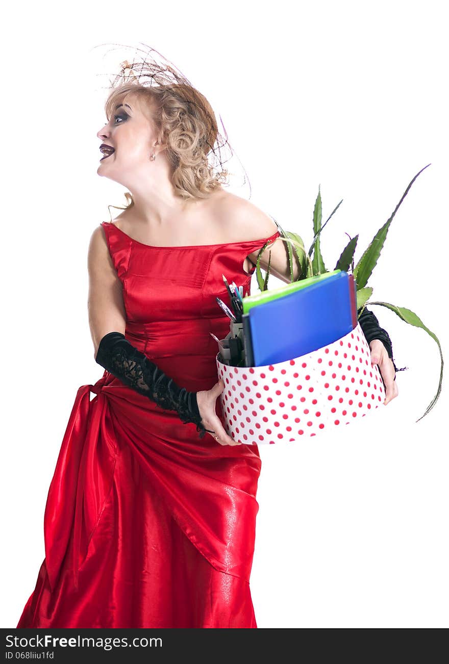 Fired actress in a red dress with a box of things express her emotions on a white background. Fired actress in a red dress with a box of things express her emotions on a white background