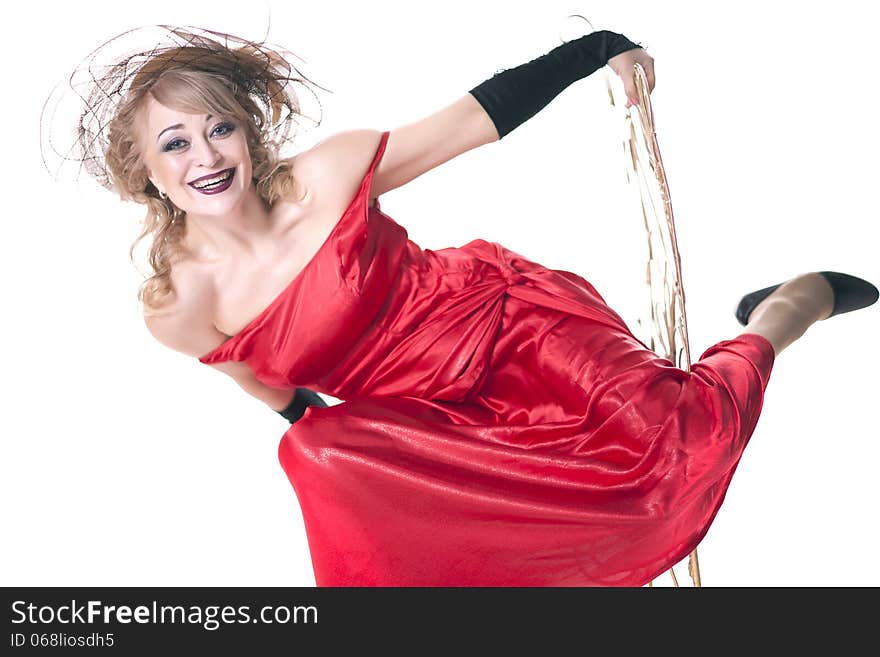 Woman in a red dress posing on a chair on a white background