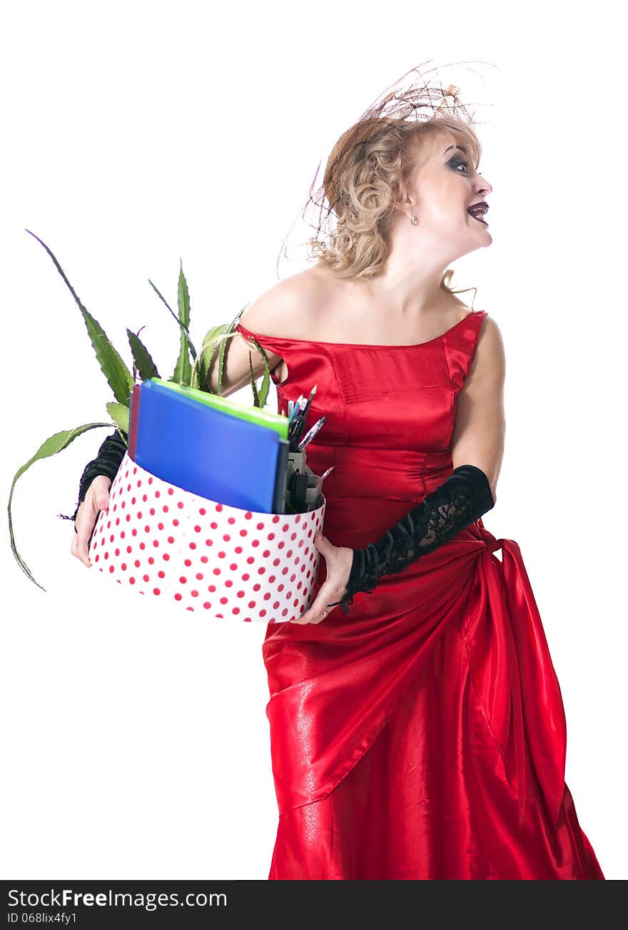 Fired actress in a red dress with a box of things express her emotions on a white background. Fired actress in a red dress with a box of things express her emotions on a white background