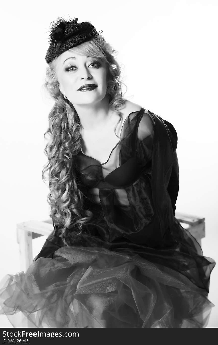 Portrait of woman with curly hair in pretty hat.Black and white