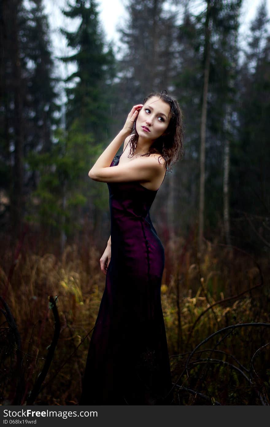 Dark portrait of woman under rain