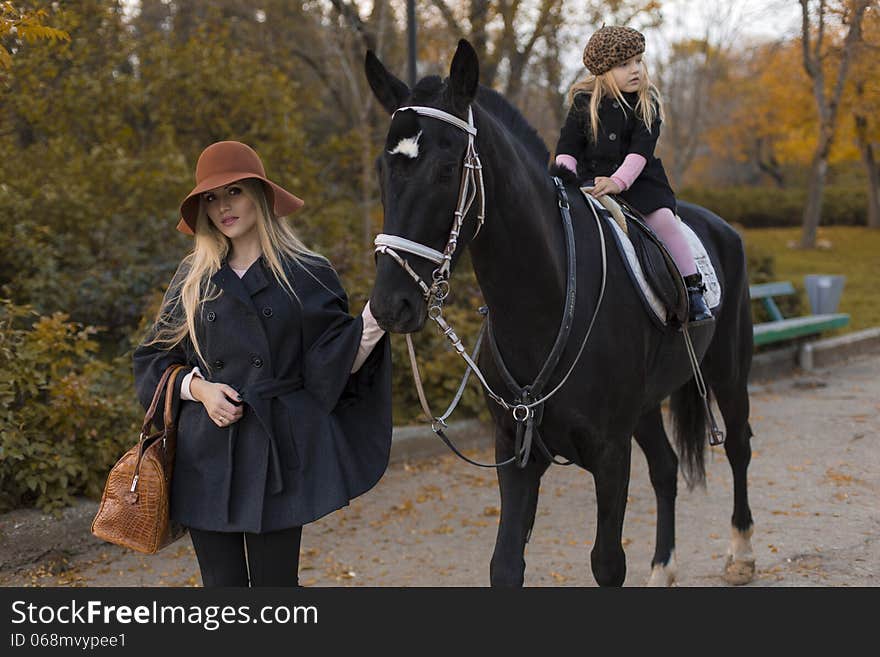 Happy family with black horse