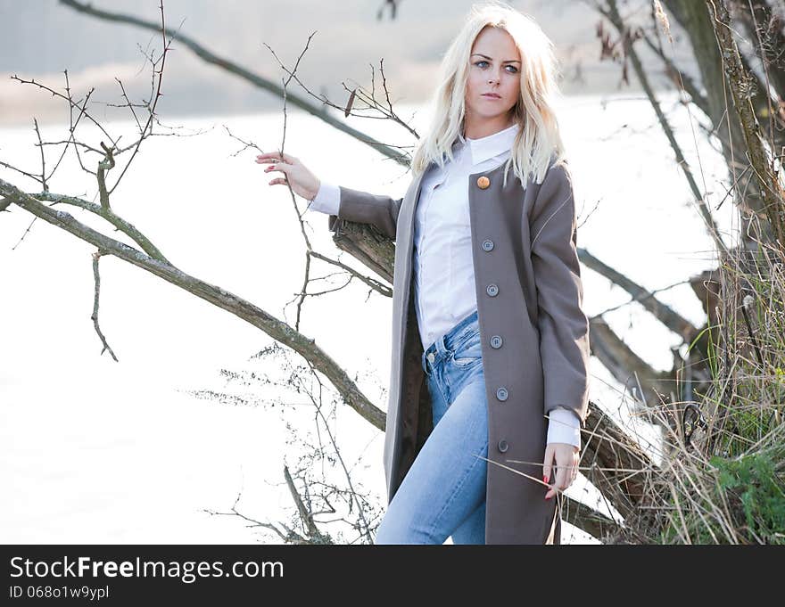 Young beautiful girl in the autumn river