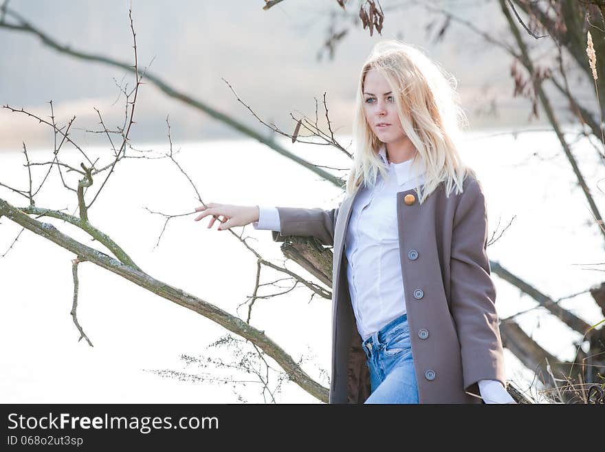 Young beautiful girl in the autumn river