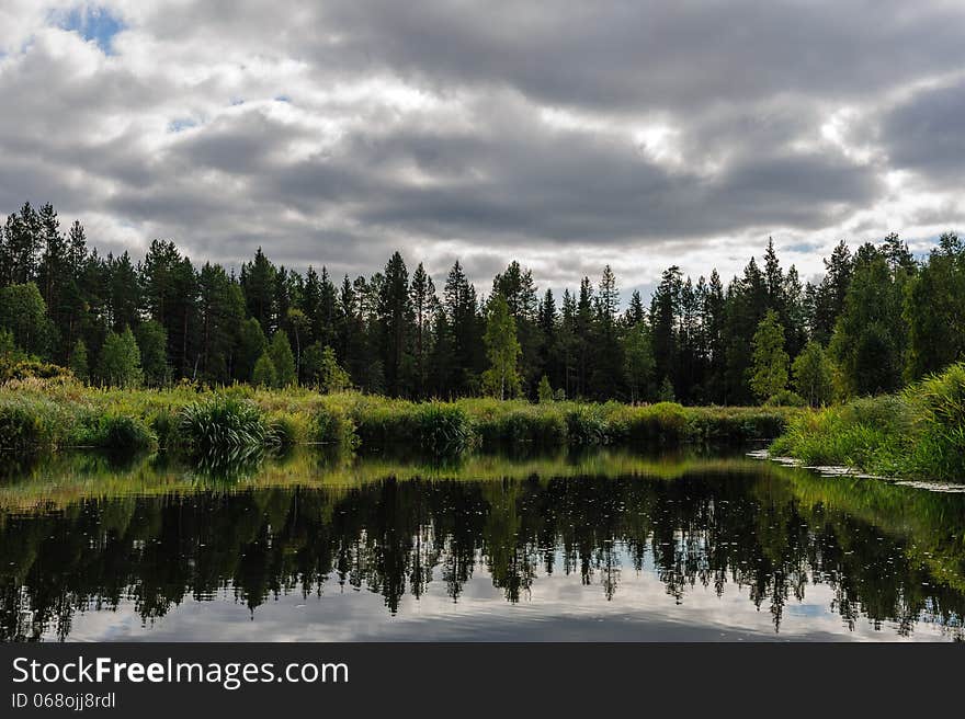 Beautiful river coast in the wild Karelian (Karjala) woods. Beautiful river coast in the wild Karelian (Karjala) woods