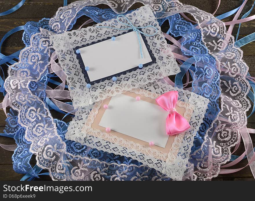 Pink and blue greeting cards on wooden background