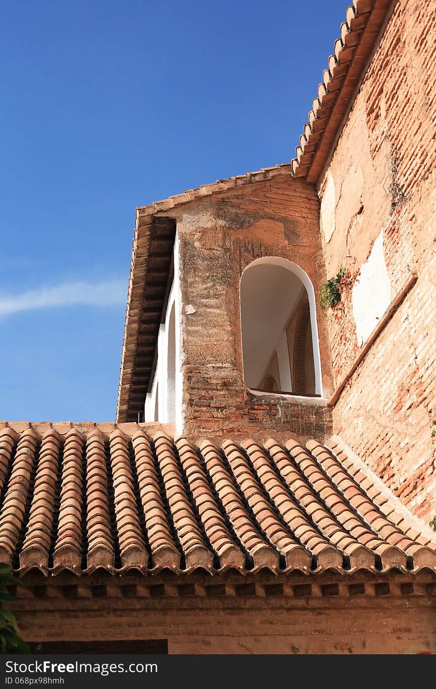 Nice old Spanish house with tiling roof and arch window