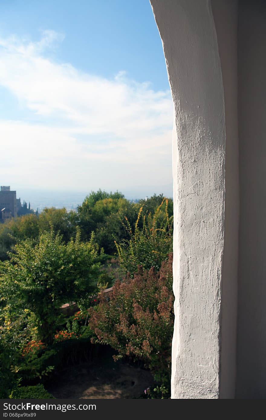 View at summer nature landscape across big arch window