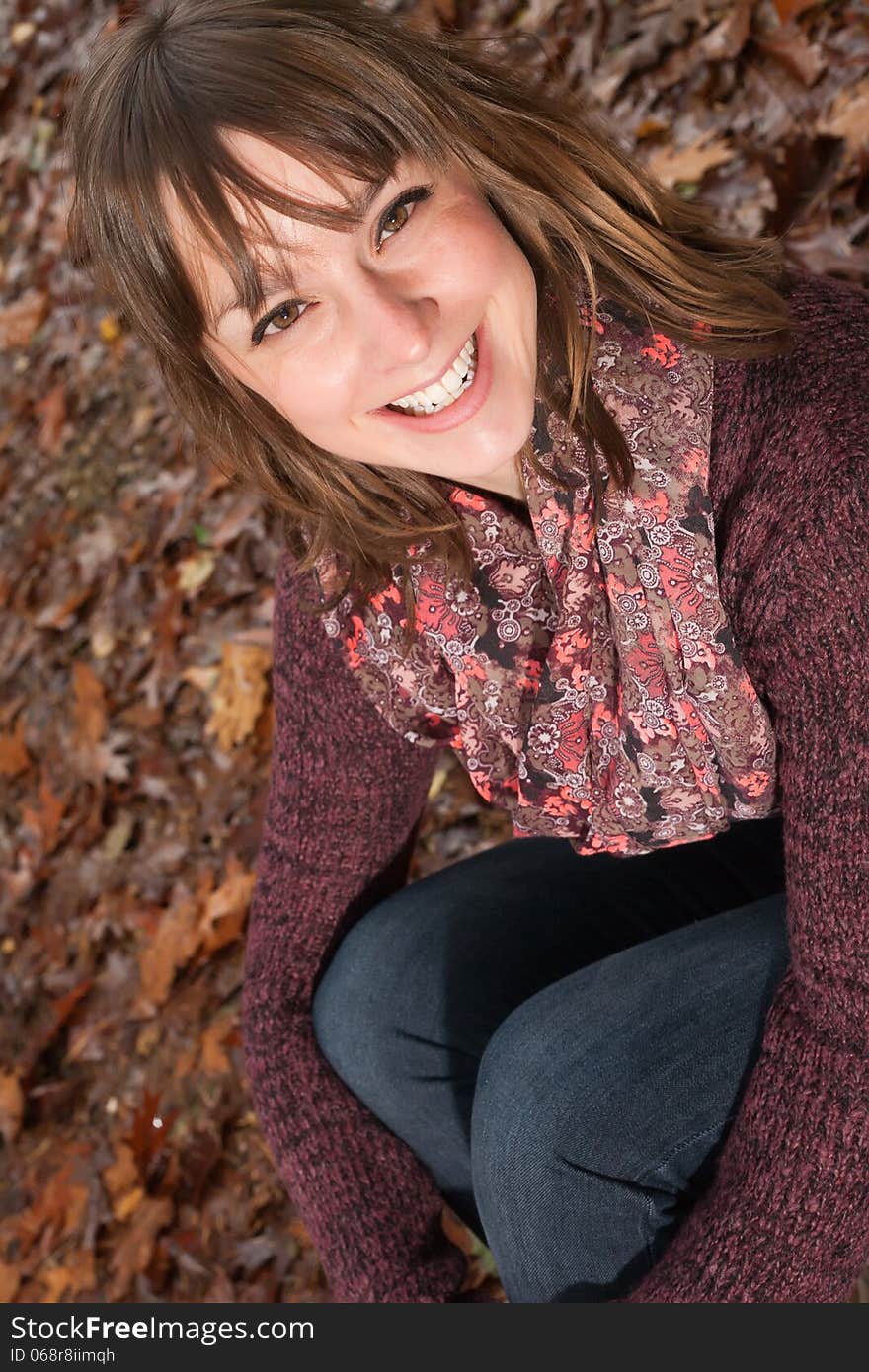 Happy girl on the autumn ground