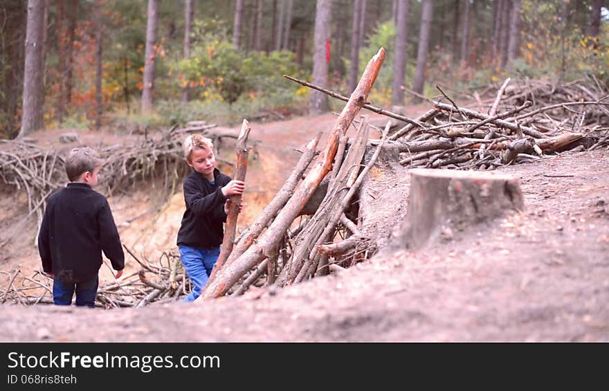 Two boys building a shanty in a forest. Two boys building a shanty in a forest