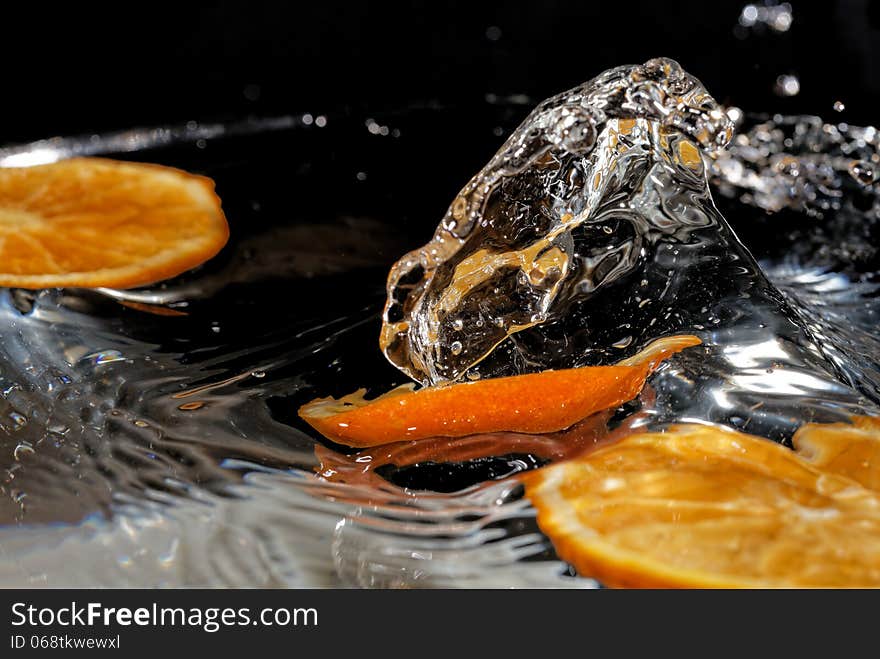 Slice of orange falling into the water. Slice of orange falling into the water