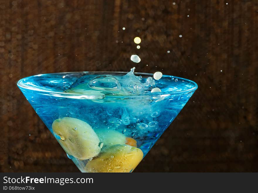 Blue Martini drink with green olives