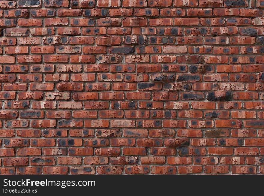 Brown brick wall with spots