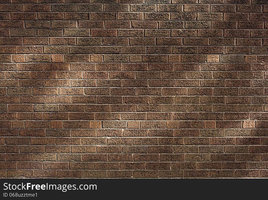 Brown brick wall with light spots