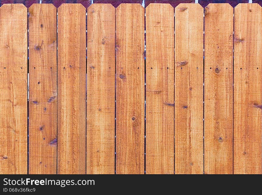 Orange wooden fence with marks