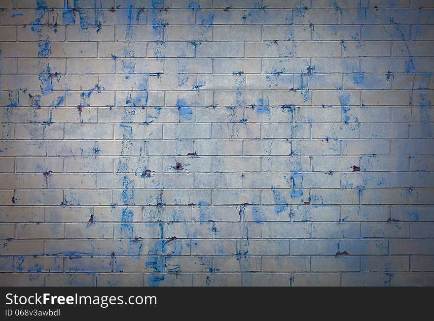 White brick wall with blue spots